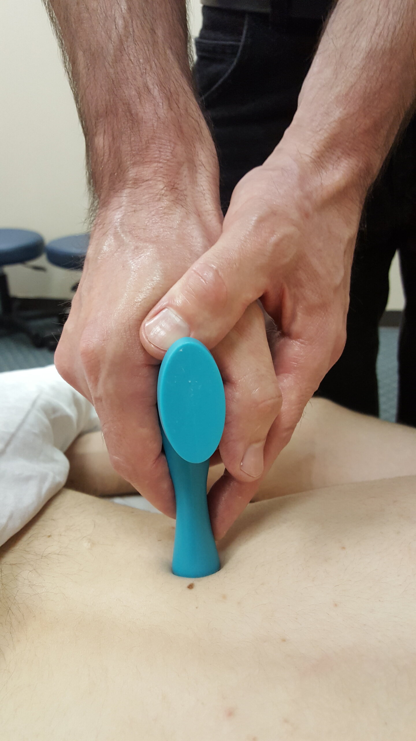 Two Hands on a Massage Tool